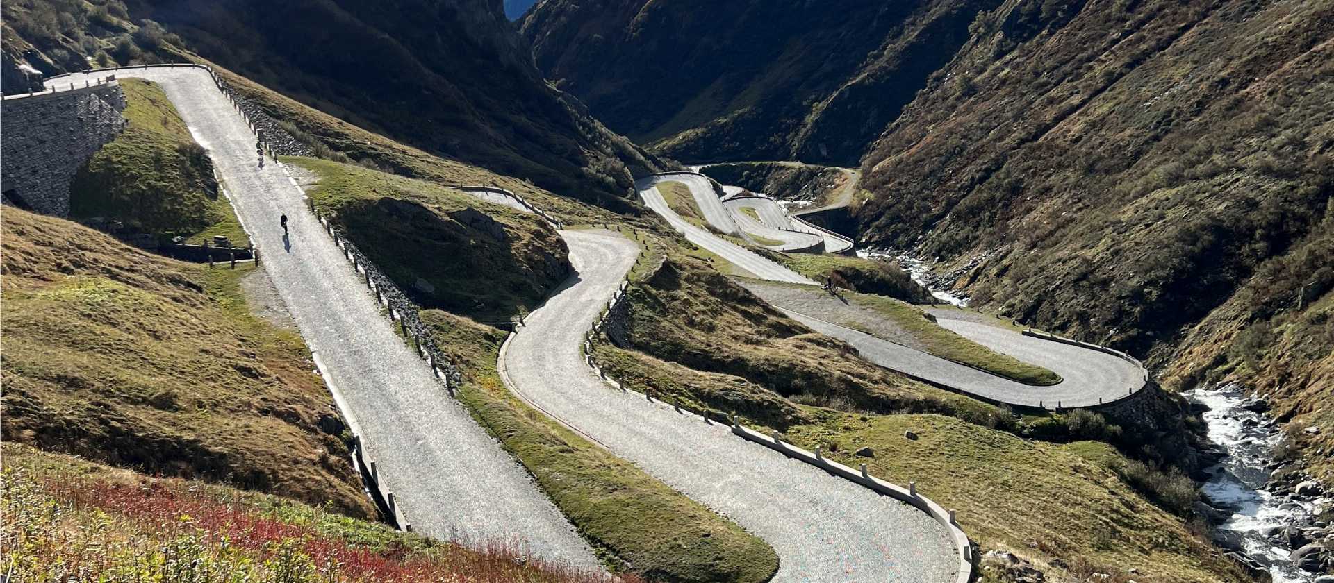 Cyclists descending the dramatic switchbacks from the Gotthard Pass