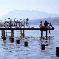 Swiss Chocolate Cycle #3 Cyclists on jetty in lake