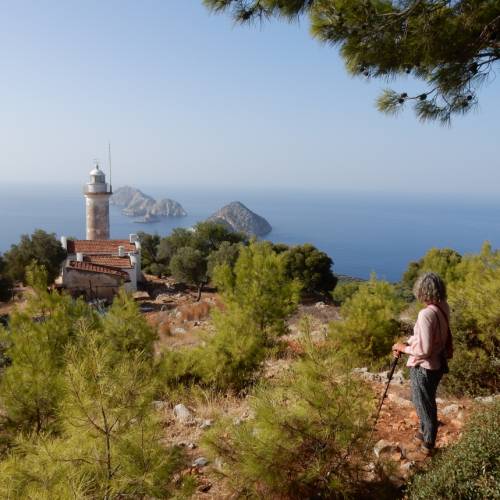 Hiker enjoying the view of Cape Gelidonia lighthouse and the 'Five Islands'