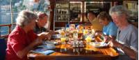 Cyclists enjoy breakfast on board their comfortable boat in Turkey