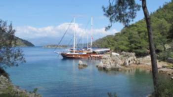 Boat moored at the ruins of 'Cleopatra's baths' on our Turkey Walk & Sail | Kate Baker