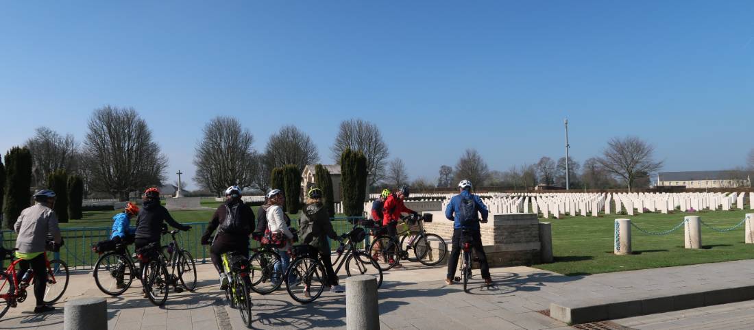 Cyclists stopped outside Bayeux Cemetery in Normandy |  <i>Kate Baker</i>