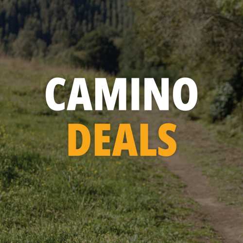 Camino de Santiago walking trail winds through quiet green countryside in Spain.