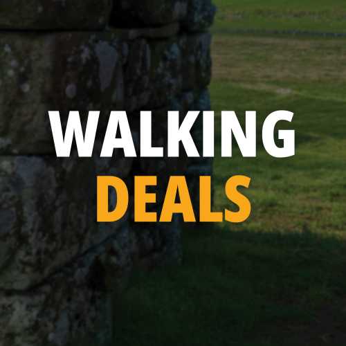 Walking holiday promotion overlaid on a stone wall and green field backdrop.