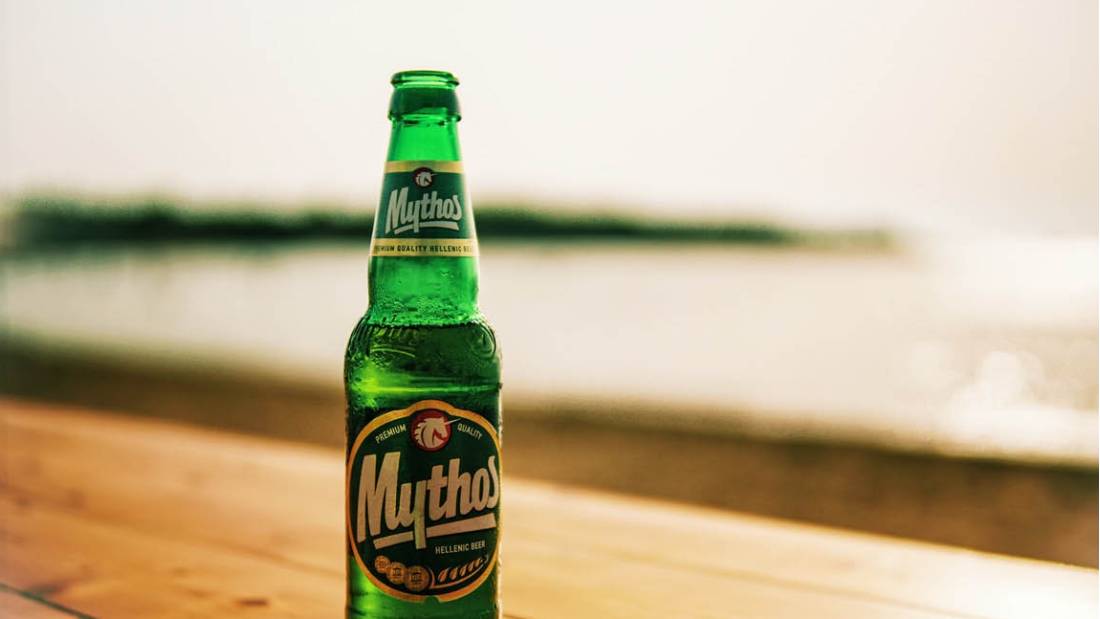 Enjoying a cold beer by the beach in Greece