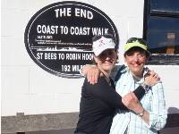 Happy hikers at the end of the Coast to Coast Trail in Robin Hood's Bay |  <i>John Millen</i>