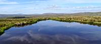 Moorland reflections in a tarn | John Millen