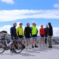 Happy cyclist faces after making it to the top of the Col