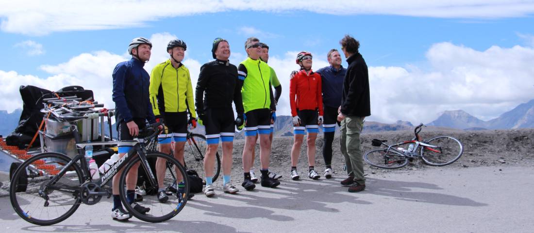 Happy cyclist faces after making it to the top of the Col