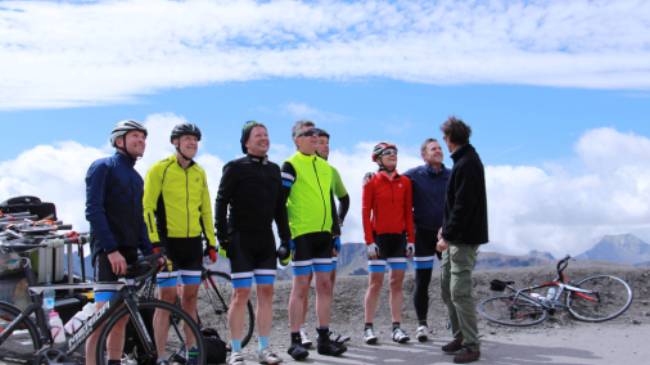 Happy cyclist faces after making it to the top of the Col
