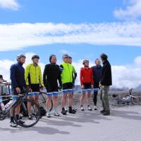 Happy cyclist faces after making it to the top of the Col