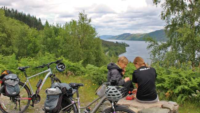 Cyclists overlooking Great Glen & Loch Ness in Scotland | Janette Crighton