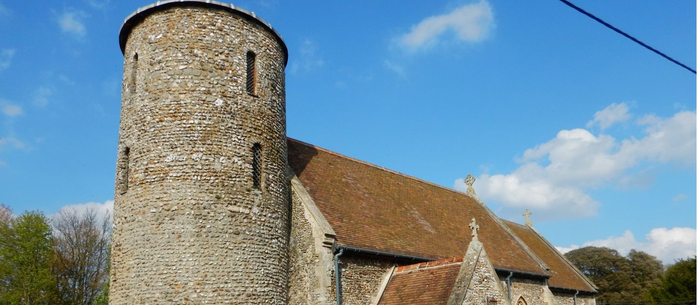Norfolk Coast Path passes a flint round-tower church and churchyard | Peter Wells