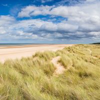 Norfolk Coast Path winds through grassy dunes above Holkham Beach