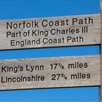 Norfolk Coast Path signpost pointing toward King's Lynn and Lincolnshire | Shutterstock