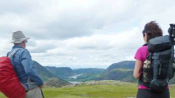 A couple of hikers take in scenes on England's beautiful Lake District