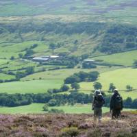 A couple enjoying the beautiful scenery on Wainwright's Coast to Coast | John Millen