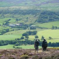 A couple enjoying the beautiful scenery on Wainwright's Coast to Coast | John Millen