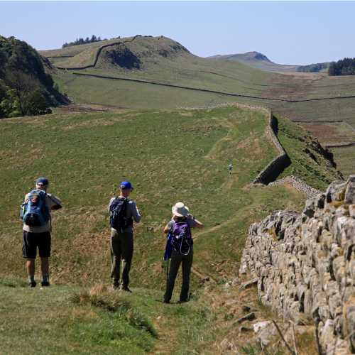 Hikers taking in Hadrian's Wall in England
