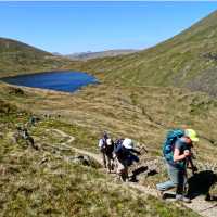 Hikers above Grizedale Tarn in the Lake District | John Millen