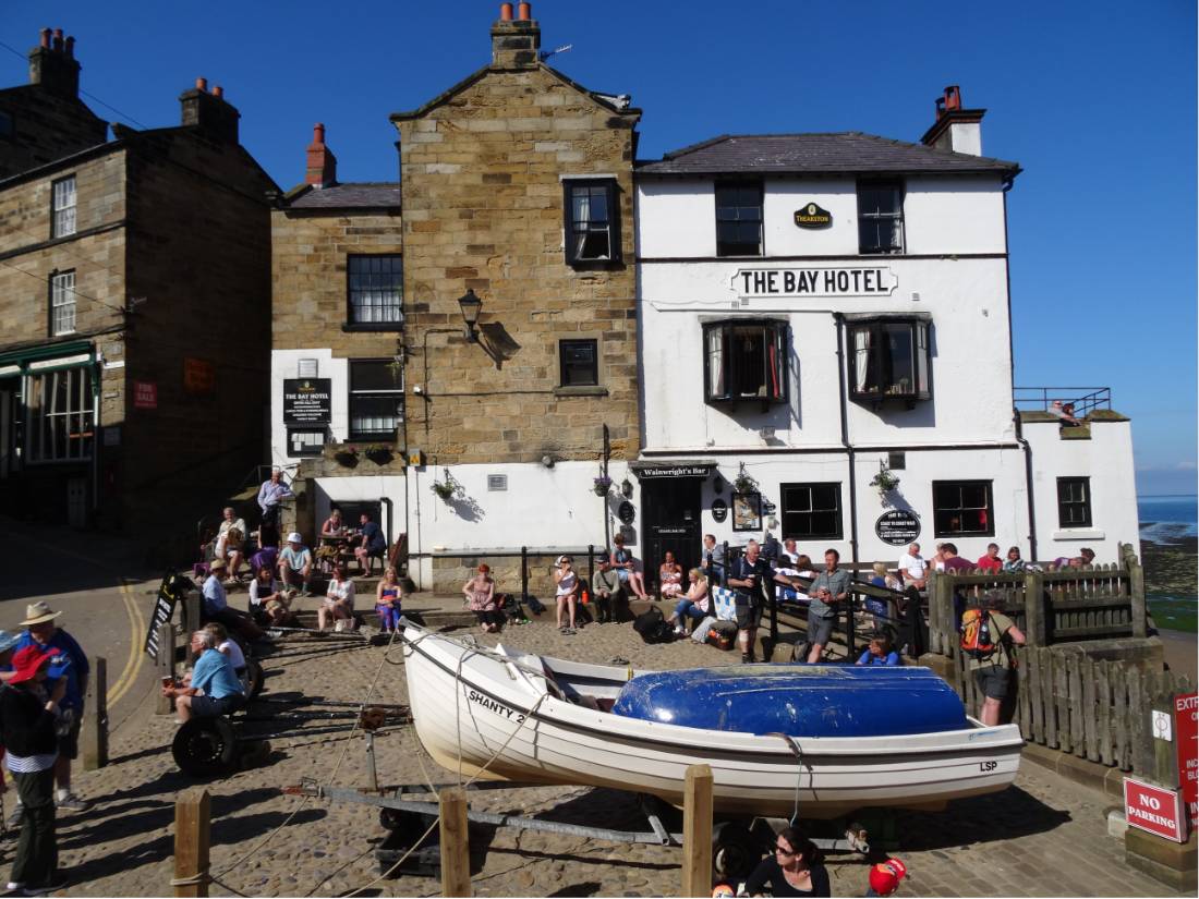 Walkers celebrating the end of the Coast to Coast in Robin Hood's Bay |  <i>John Millen</i>