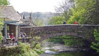 Walkers taking a rest at Grasmere Bridge on the Coast to Coast trail