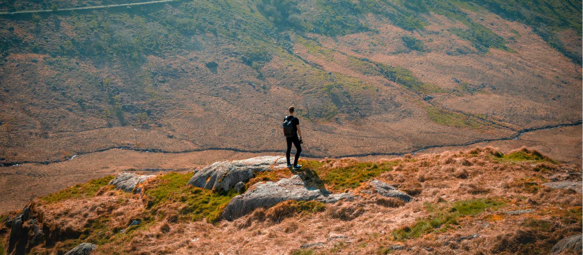 Hiker on a lush hillside in Snowdonia National Park
 | Zoltan Fekeshazy
