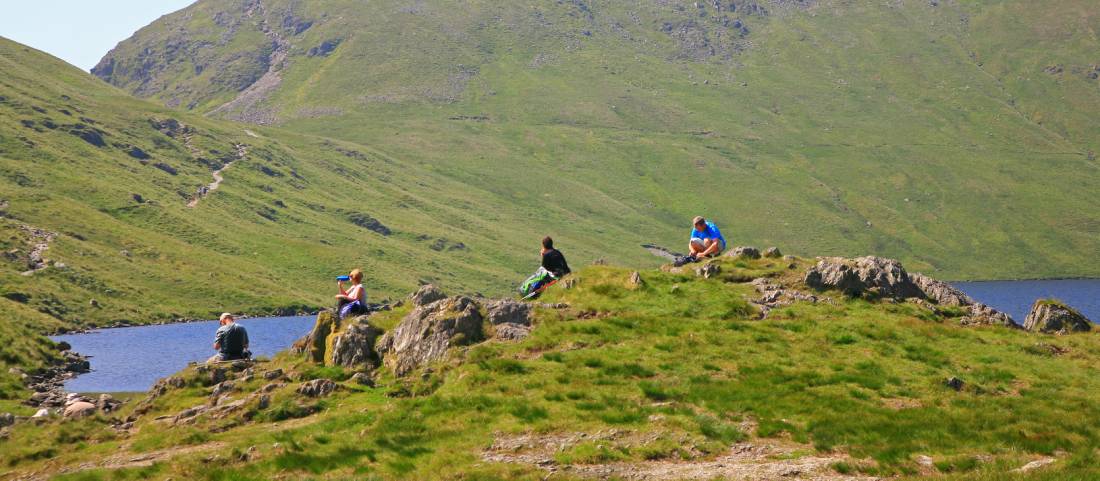 Walkers enjoy a break at Grisedale Tarn mountain lake | <i>John Millen</i>