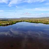 Moorland reflections in a tarn | John Millen