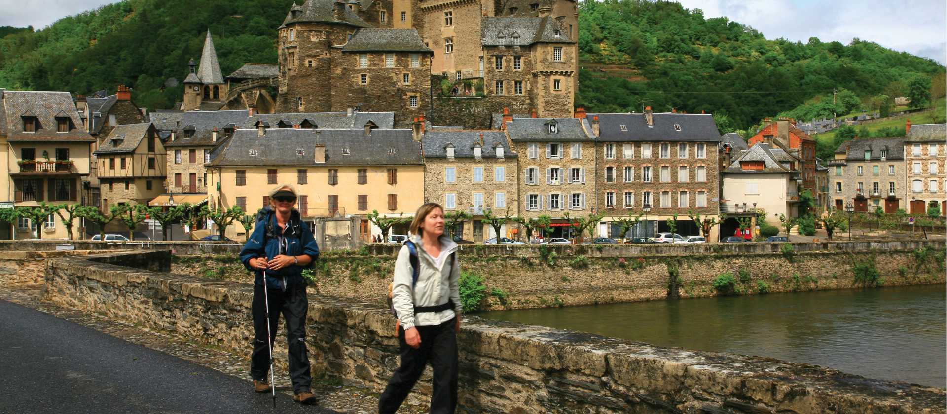 Hikers leaving Estaing on the Way of St James