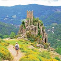 A walker follows the path to Chateau de Rochebonne | Keith Starr