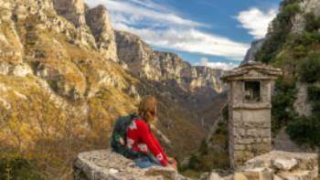 A hiker looking into the Vikos Gorge