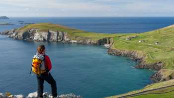 Hiker enjoying the view from Slea Head, Dingle