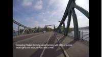 During the Cold War, the Glienicke Bridge was a restricted border crossing. Connecting Potsdam (formerly in East Germany) with Berlin, it is where secret agents and secret services used to meet. View the Berlin Wall Trail Cycle tour: https://www.utracks.com/Germany/Cycling/Berlin-Wall-Trail-Cycle  It became known as the ‘Bridge of Spies’ as prisoner exchanges took place here between the East & West. What was once a complicated crossing can now easily be crossed when cycling the Berlin Wall Trail.  About the Berlin Wall Trail Cycle Tour  The Berlin Wall, a onetime symbol of division, now provides a peaceful path for cyclists looking to explore one of Germany's most dynamic cities in an entirely different way.   This urban cycle adventure will uncover the diversity of Berlin offering a unique insight into the numerous faces of the city, marked by historical adversity yet celebrated in the vibrancy of the landscapes and landmarks which define it.   The 160km loop structure that was brought down in 1989 has now given rise to the Wall Trail (Mauerweg) and cycling along the former borderline between East and West Germany is the ideal way to stop and soak in the history of the many checkpoints, that are now sites of interest, as well as other fascinating relics.   During this circuit ride from Oranienburg through Berlin and passing by important sites such as the Brandenburg Gate, a symbol of peace, and Checkpoint Charlie, once separating the American-controlled zone of West Berlin from the Soviet-controlled East Berlin.   The ride along the former patrol roads takes in forests and grand parks, such as the World Heritage listed parks and palaces of Potsdam, namely the Sanssouci palace complex, where philosopher Voltaire once stayed and the Spandau Forest, on a circuit returning to Oranienburg. At night stay in comfortable hotels chosen for their location and service.  About UTracks  UTracks have over 450 trips across the active travel spectrum: from relaxed cycling in the Loire Valley, to discovering iconic Camino trails, to challenging hikes around Mont Blanc.   Walking or cycling, 2-star or 4-star, small group or self guided, land, river or sea - UTracks can help you explore Europe exactly the way you want. Learn more at https://www.utracks.com/  Stay in touch with UTracks: https://instagram.com/utrackstravel https://twitter.com/UTracks_Travel https://www.facebook.com/UTracks https://www.pinterest.com.au/utracks/ https://www.utracks.com/blog https://www.youtube.com/user/UTracksTravel