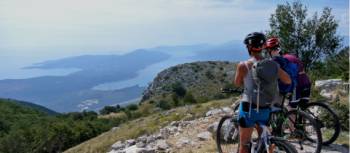 Cyclists enjoying the view of the Bay of Kotor while on the Croatia to Albania Coastal Cycle