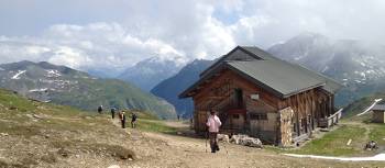 Hikers descending to the Bonhomme Refuge in the French Alps | Kate Baker