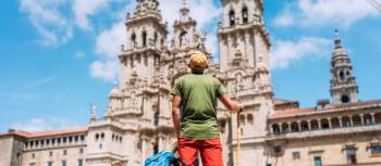 A pilgrim admires the incredible architecture of the Cathedral of Santiago de Compostela.