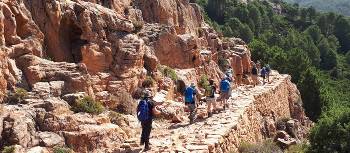 The sun shining down a group in mountainous Corsica | Paul Ensor