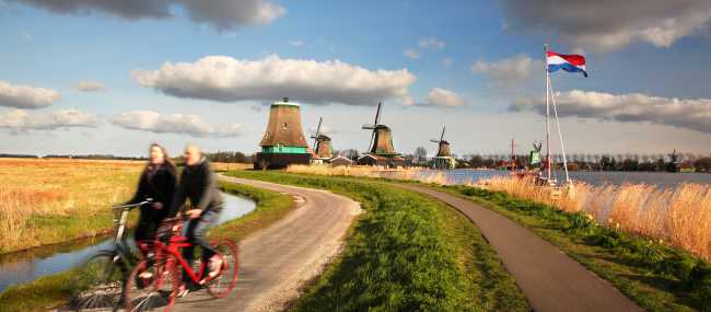 Cycling past windmills in Holland